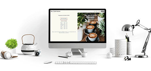 image of a desk with a computer, lamp and plant showing a Web Studio X website on the screen