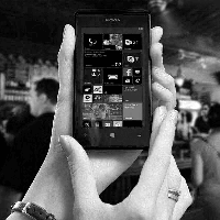 black and whiteimage of a person holding a mobile phone